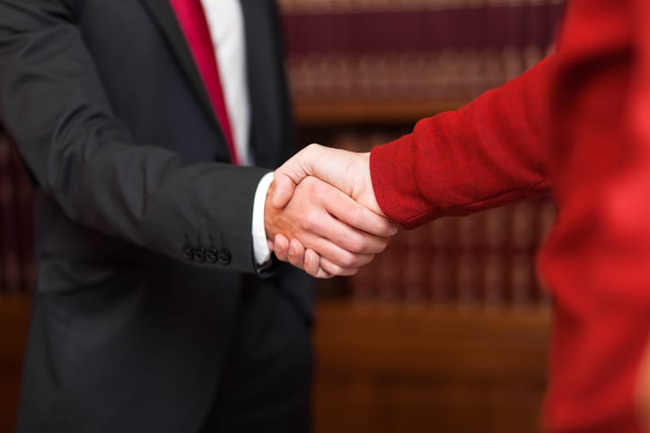 Law Office of Tipton-Downie | Attorney at Law | Vidalia, GA | Businessman giving an handshake to a customer